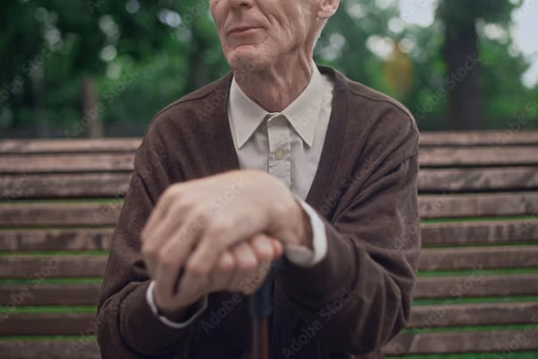 Eldery man resting on park bench - purchase in July