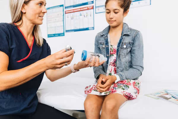 Professional showing child inhaler technique