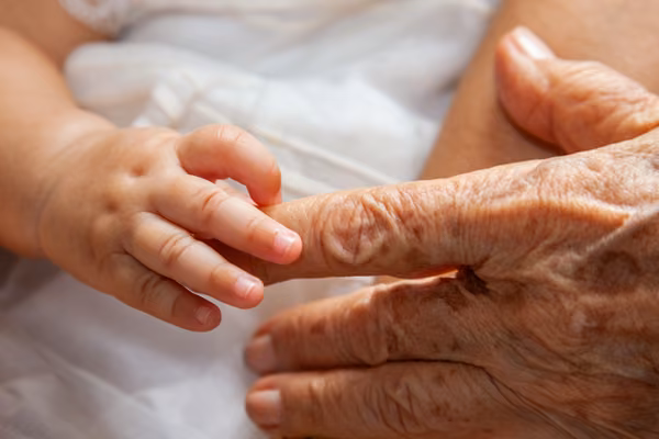Baby and grandparent holding hands